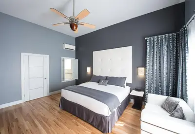 a bedroom with a bed and a couch at Kent Hotel in Miami Beach