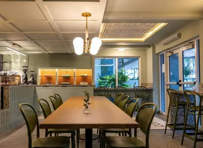 a dining room with a table and chairs at Balfour Miami Beach, a Registry Collection Hotel in Miami Beach