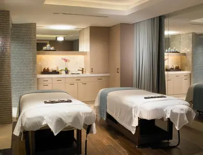 two beds in a room with a kitchen at The Palms Hotel & Spa in Miami Beach