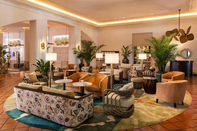 a lobby with couches and chairs and tables at The Palms Hotel & Spa in Miami Beach
