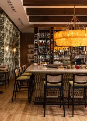 a bar in a restaurant with chairs around it at The Palms Hotel & Spa in Miami Beach