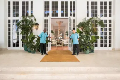 two men in blue shirts standing in front of a door at The Palms Hotel & Spa in Miami Beach