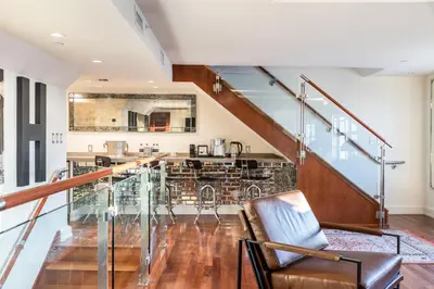 a living room with a staircase and a chair at National Hotel, An Adult Only Oceanfront Resort in Miami Beach