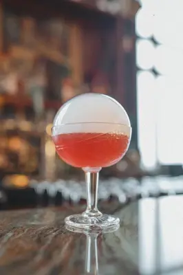 a drink in a glass sitting on a table at National Hotel, An Adult Only Oceanfront Resort in Miami Beach