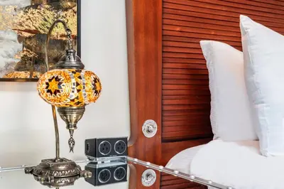 a bedroom with a bed and a lamp and speakers at National Hotel, An Adult Only Oceanfront Resort in Miami Beach
