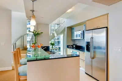 an open kitchen with a stainless steel refrigerator at Marenas Beach Resort in Miami Beach