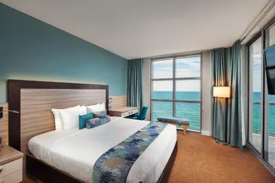 a bedroom with a large bed and a large window at Marenas Beach Resort in Miami Beach