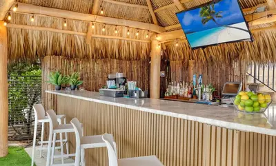 a bar in a resort with a television above it at Marenas Beach Resort in Miami Beach