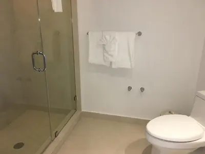 a bathroom with a toilet and a glass shower at Hide House in Hollywood