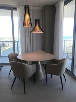 a dining room with a table and chairs and lights at Hide House in Hollywood