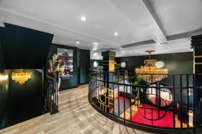 a lobby with a spiral staircase with a chandelier at Beacon South Beach Hotel in Miami Beach