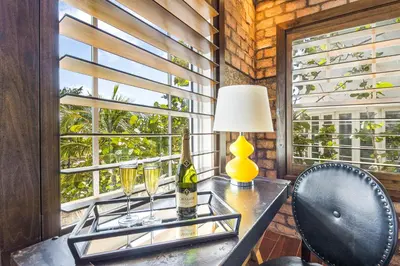 a room with a table with a lamp and a window at Cavalier South Beach Hotel in Miami Beach