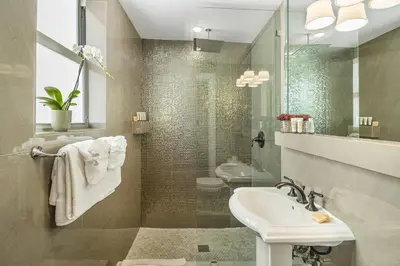 a bathroom with a sink and a shower and a toilet at Cavalier South Beach Hotel in Miami Beach