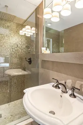 a bathroom with a white sink and a shower at Cavalier South Beach Hotel in Miami Beach