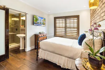 a bedroom with a bed and a bathroom with a sink at Cavalier South Beach Hotel in Miami Beach