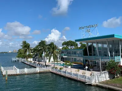 a dock with a building on the water at International Inn on the Bay in Miami Beach
