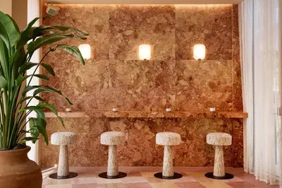 a room with stools in front of a wall at The Shelborne by Proper, a Member of Design Hotels in Miami Beach