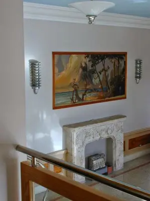a living room with a painting above a fireplace at Viscay Hotel in Miami Beach