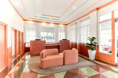 a living room with two chairs and a table at Waldorf Towers South Beach in Miami Beach
