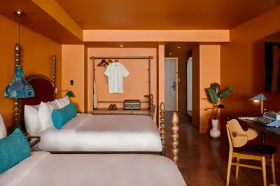 a bedroom with a bed and a desk and a desk at Mayfair House Hotel & Garden in Miami