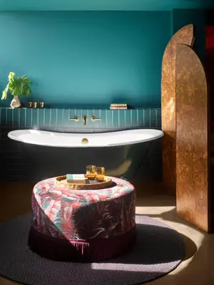 a bathroom with a bath tub and a large bath tub at Mayfair House Hotel & Garden in Miami