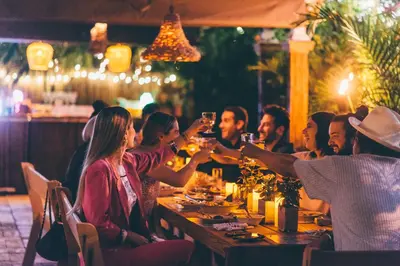 a group of people sitting at a table drinking wine at Freehand Miami in Miami Beach
