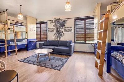 a living room with a couch and a table at Freehand Miami in Miami Beach
