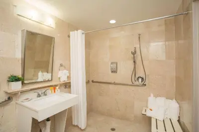 a bathroom with a sink and a shower at Best Western Plus Atlantic Beach Resort in Miami Beach