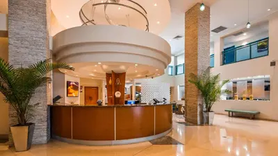 a large lobby with a reception desk in a building at Best Western Plus Atlantic Beach Resort in Miami Beach