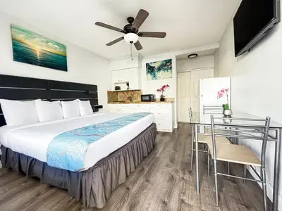 a bedroom with a large bed and a desk at Greniers in Hollywood