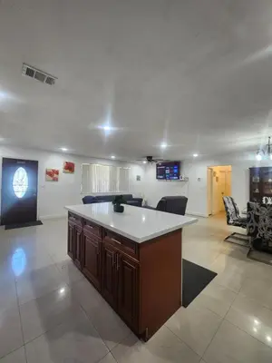 a kitchen with a island in a living room at The Jazzy Escape in Miami