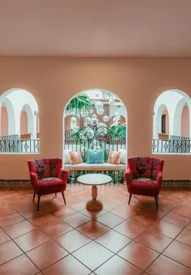 a lobby with two chairs and a table in a room at Casa Faena Miami Beach in Miami Beach