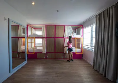 a little girl standing in a room with a bedroom at Viajero Miami in Miami Beach