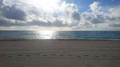 a beach with footprints in the sand and the ocean at Sea View Hotel in Miami Beach