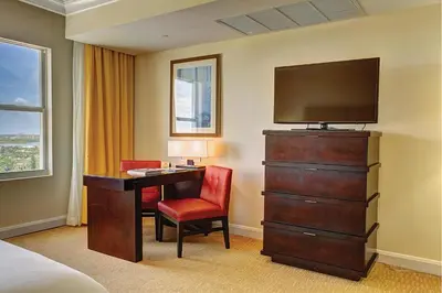 a hotel room with a desk and a television at Sea View Hotel in Miami Beach