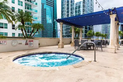 a hot tub in the middle of a city with tall buildings at Top Stay Miami Blue Brickell in Miami