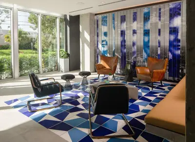 a lobby with chairs and tables and windows at Hotel Indigo Miami Brickell by IHG in Miami