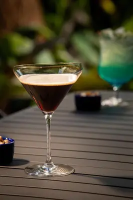 a martini glass sitting on top of a table at Hotel Indigo Miami Brickell by IHG in Miami