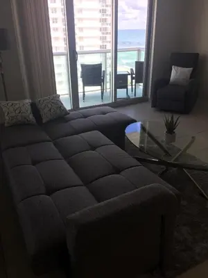 a living room with a couch and a glass table at Tides Beachfront Resort - 2 Bedroom Direct Oceanview Condo in Hollywood