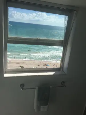 a bathroom window with a view of a beach at Tides Beachfront Resort - 2 Bedroom Direct Oceanview Condo in Hollywood