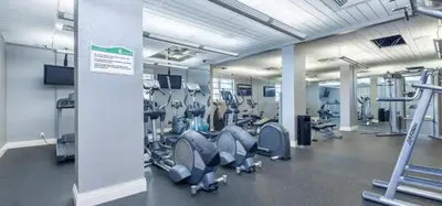 a gym with rows of treadmills and machines at Tides Beachfront Resort - 2 Bedroom Direct Oceanview Condo in Hollywood