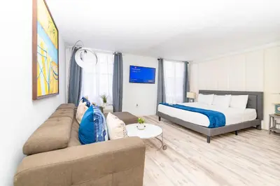 a living room with a bed and a couch at Sobe Apartments in Miami Beach