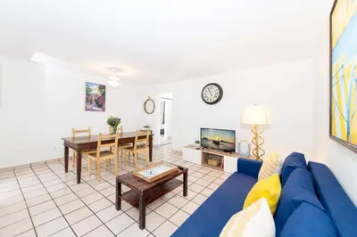 a living room with a blue couch and a table at Sofi Beach Apartments in Miami Beach