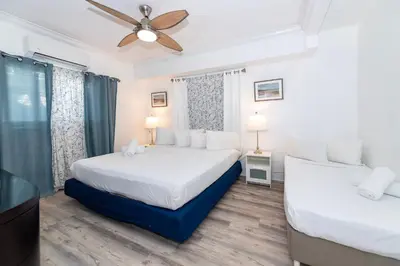 a bedroom with two beds and a ceiling fan at Sofi Beach Apartments in Miami Beach