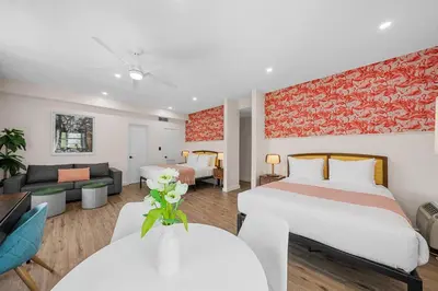 a hotel room with a bed and a living room at Greenview Hotel By Lowkl in Miami Beach