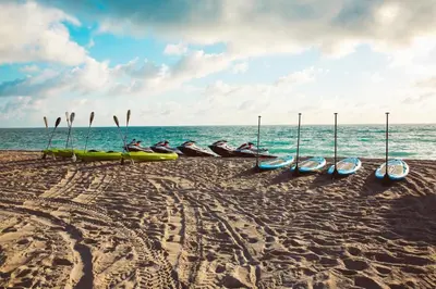 a group of kayaks on a beach near the ocean at Greenview Hotel By Lowkl in Miami Beach