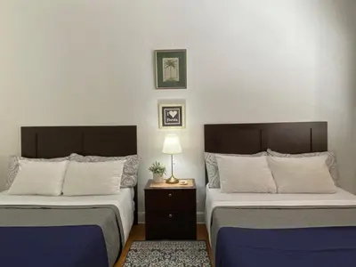 two beds sitting next to each other in a room at Miami Beach Rooms B&B in Miami Beach