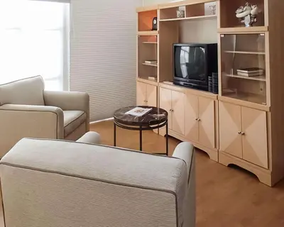a living room with a couch and a tv at Rodeway Inn South Miami - Coral Gables in Miami