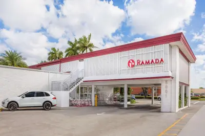 a car parked in front of a parking lot at Ramada by Wyndham Miami Springs/Miami International Airport in Miami