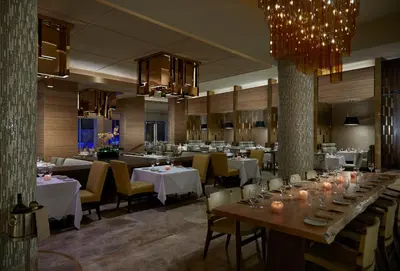 a restaurant with tables and chairs and a chandelier at Seminole Hard Rock Hotel & Casino Hollywood in Fort Lauderdale